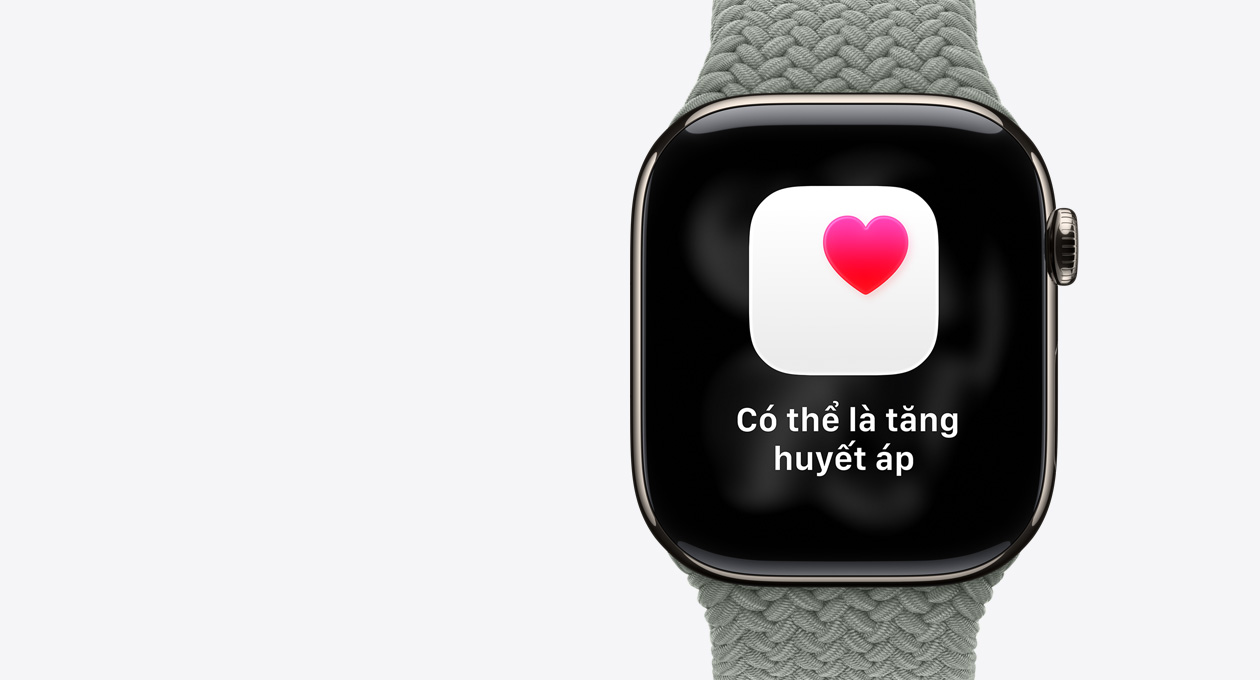 Apple Watch Series 11, natural color, titanium case, possible hypertension notification, pink heart in white box, right side exterior, Digital Crown, band, green gray Braided Solo Loop